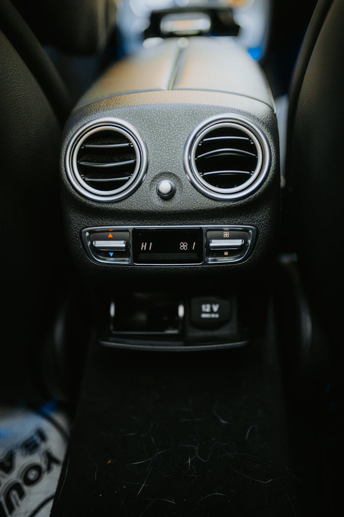 Close-up of a car's air conditioning and control panel with sleek design elements.