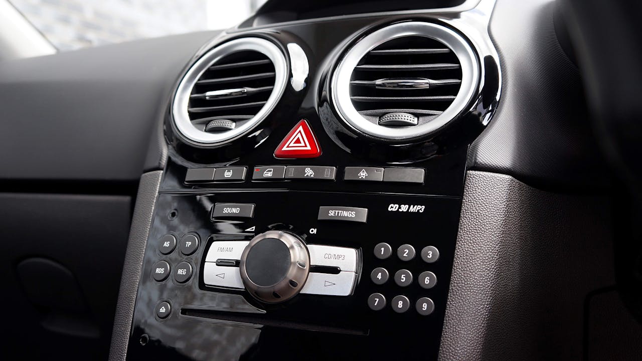 Detailed view of a car dashboard with various buttons and air vents.